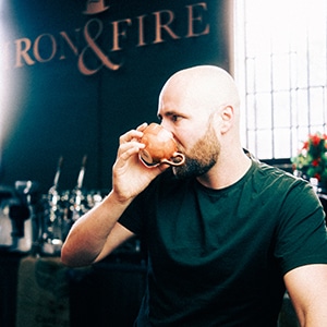 Ryan facing sideways drinking a coffee