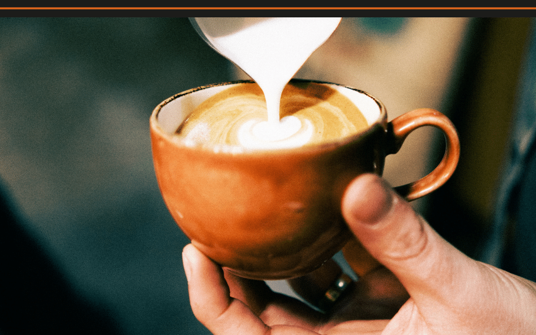 What Are Lattes? Milk poured into a terracotta cup to form latte art