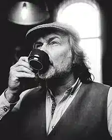 black and white image of founder Kev drinking coffee
